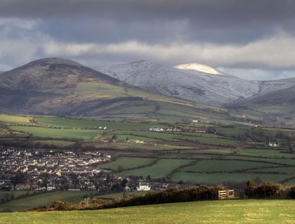 Snow covered peak of Snaefell glowing in the sun